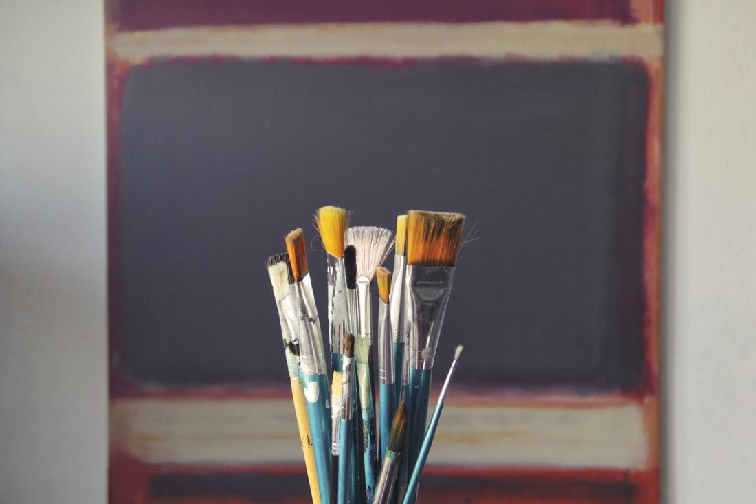 Artist's blank canvas and paint brushes